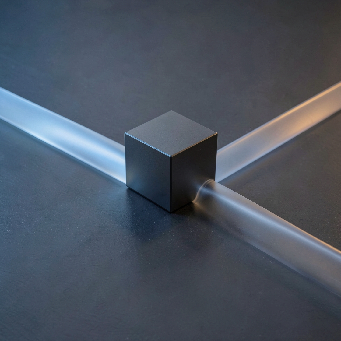 Three frosted glass paths converge on a dark cube on a slate surface.