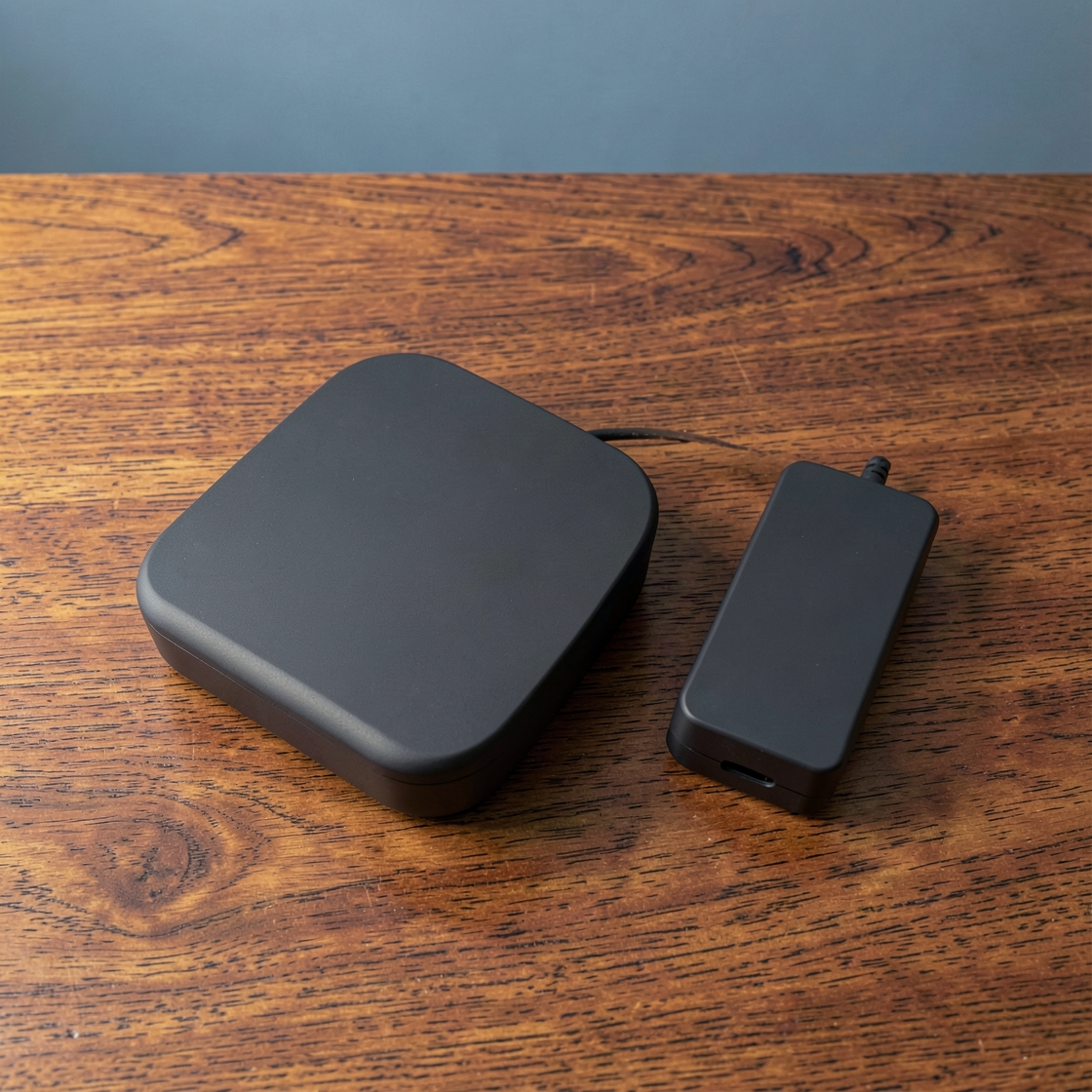 Generic compact desktop computer beside an external storage drive on a wooden desk