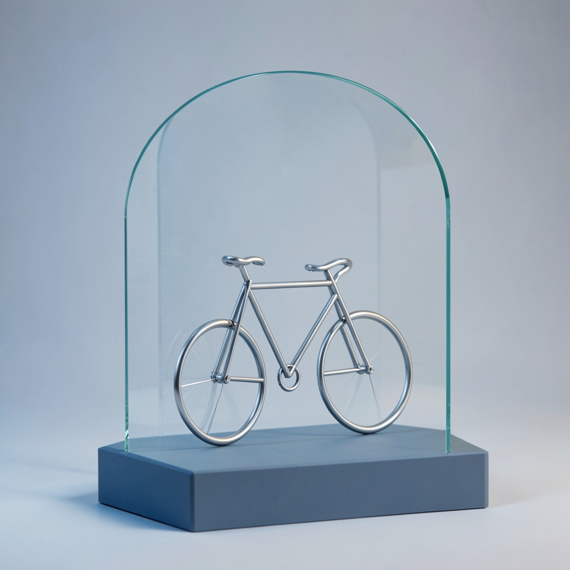 A silver wire bicycle sculpture beneath a clear glass arch on a blue-gray plinth.