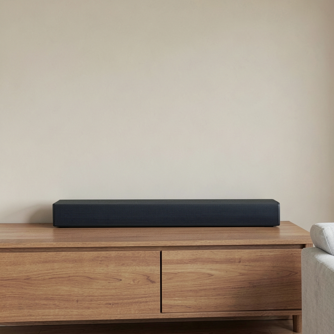 Editorial illustration of a generic unbranded soundbar on an oak console, with open space above and beside it.