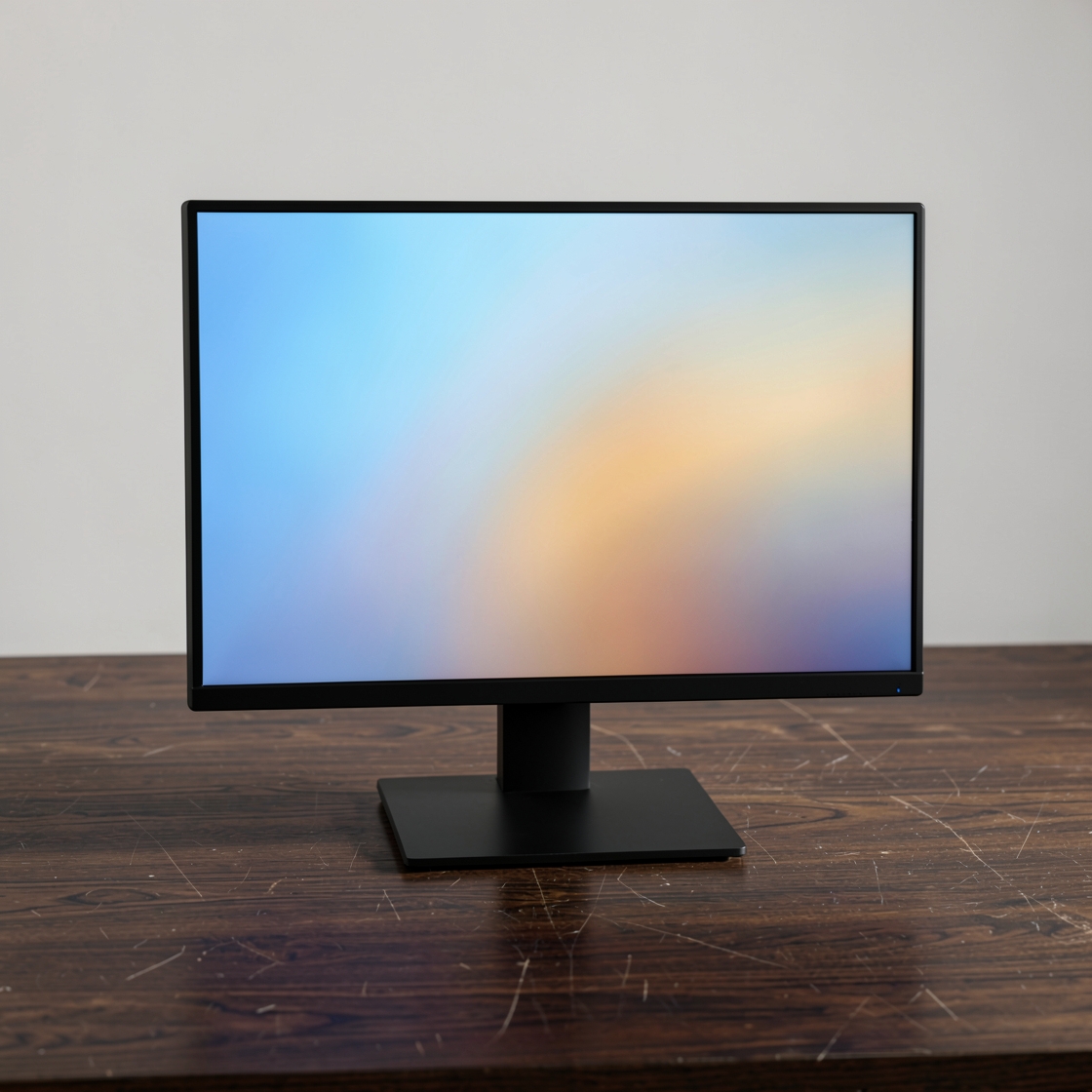 Generic desktop monitor with a blue and amber gradient on a wooden desk